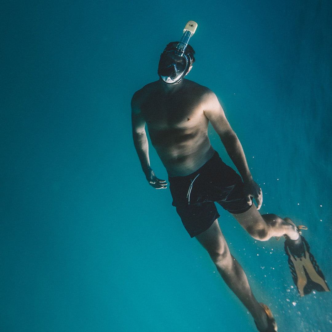 man underwater with mask snorkel and fins